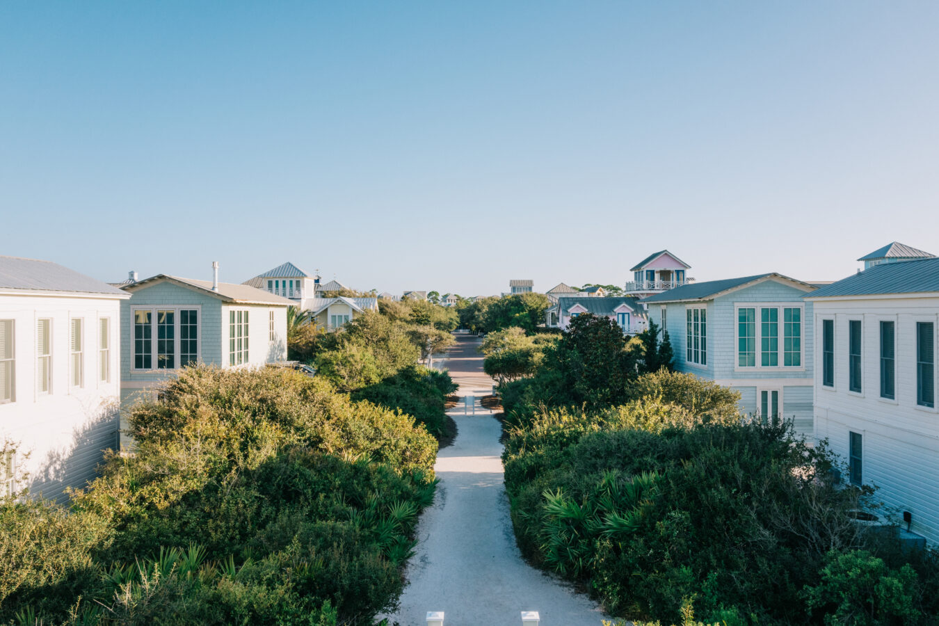 Homes in the Seaside community separated by a pathway and vegetation in Florida